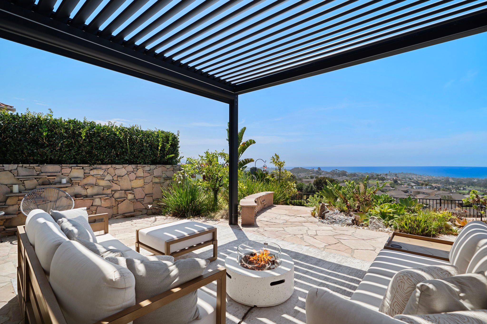 Private covered terrace with ocean views at a San Clemente home represented by Aragone and Associates