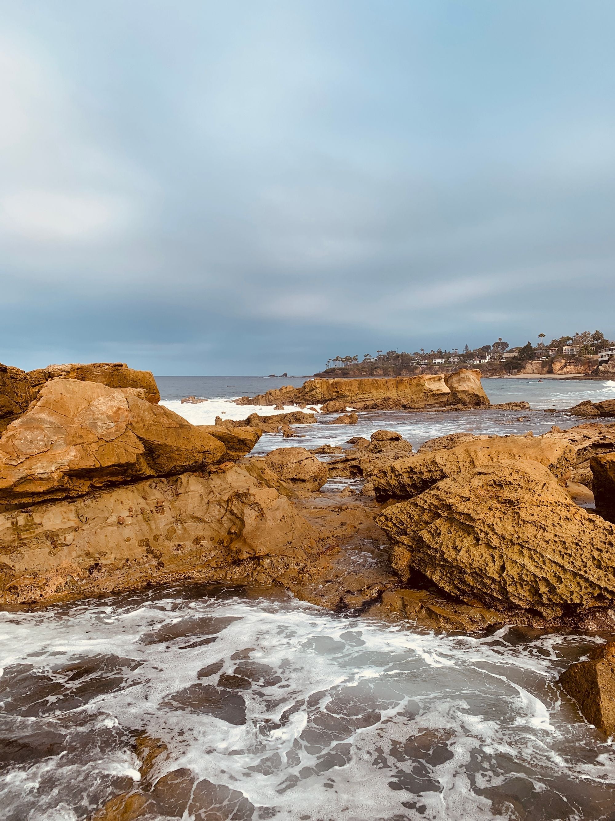 A rocky Southern California shore under a clear blue sky