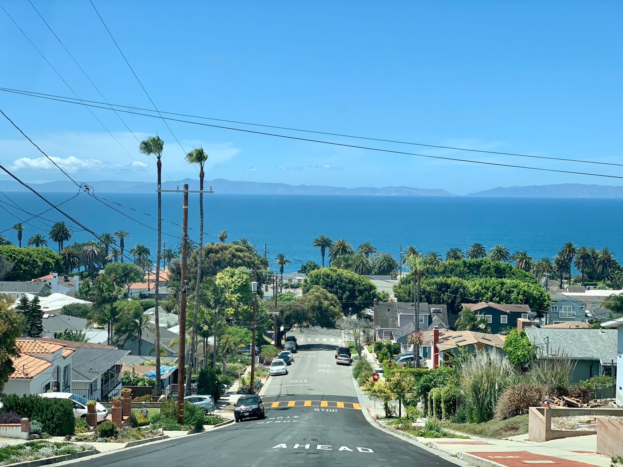 A suburban street under a clear blue sky