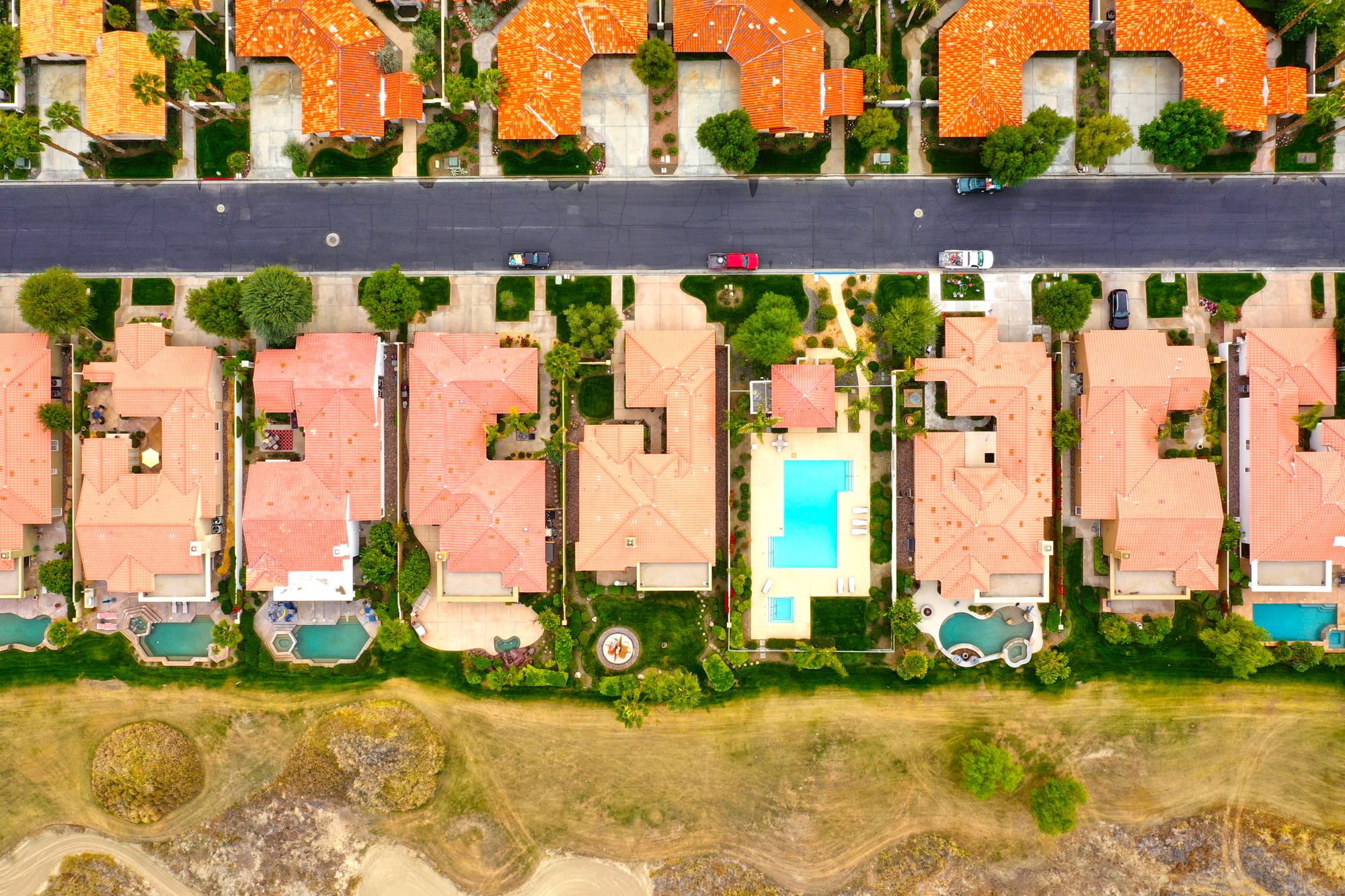 Aerial view of single family homes with swimming pools