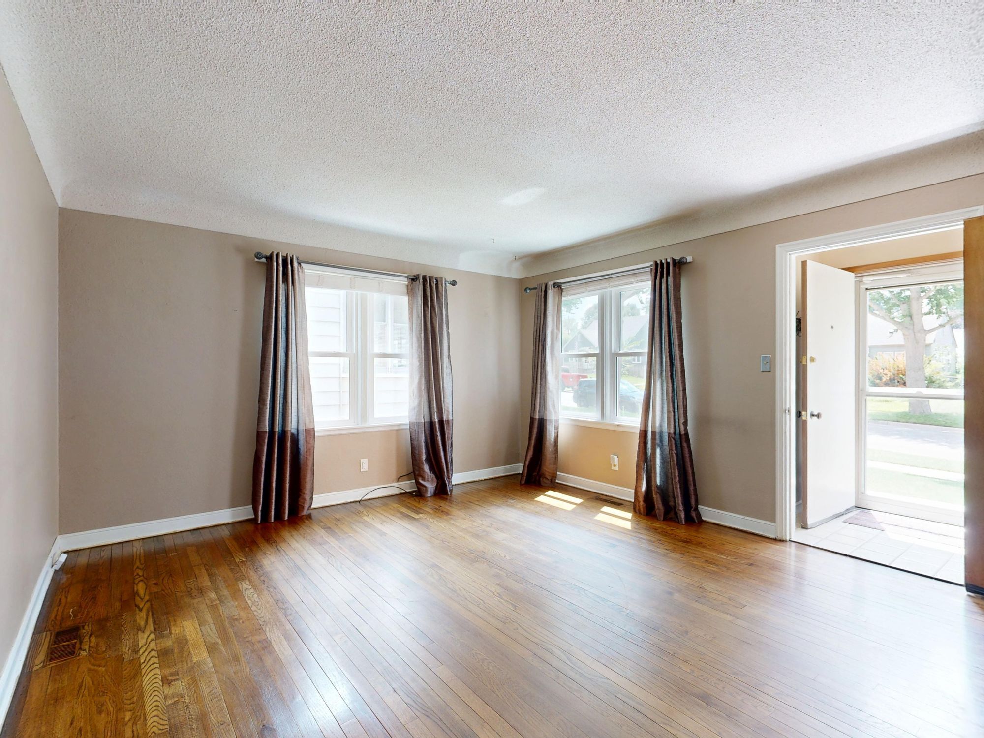 Empty living room with hardwood floors in a home being prepared for sale
