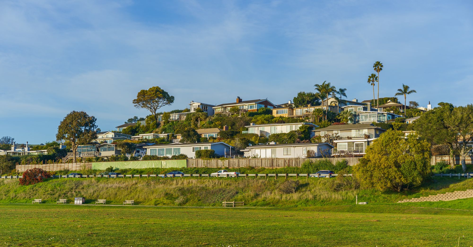 Modern homes stepped along a Southern California hillside under clear sky
