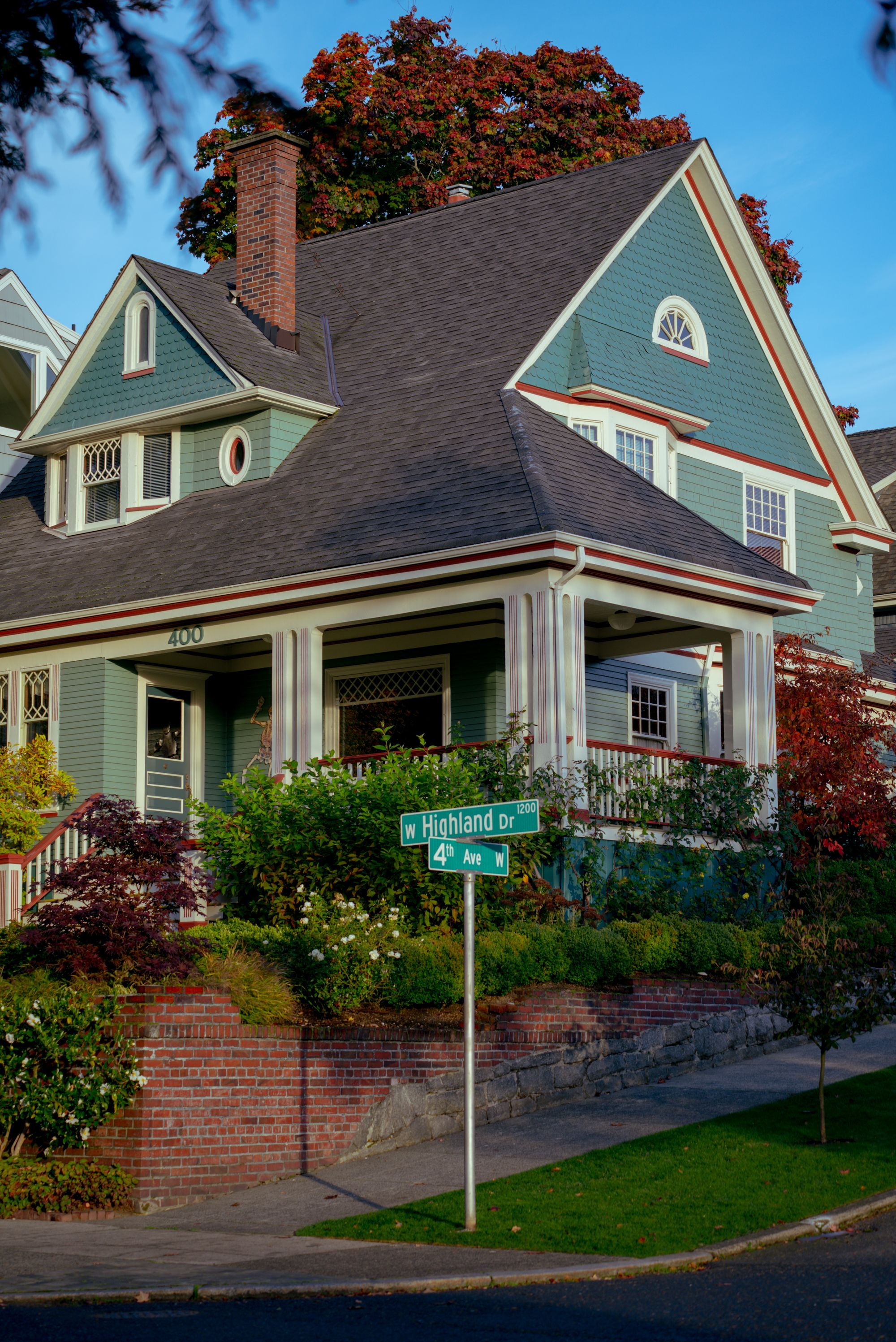 A Craftsman home with a covered porch on a tree lined residential street
