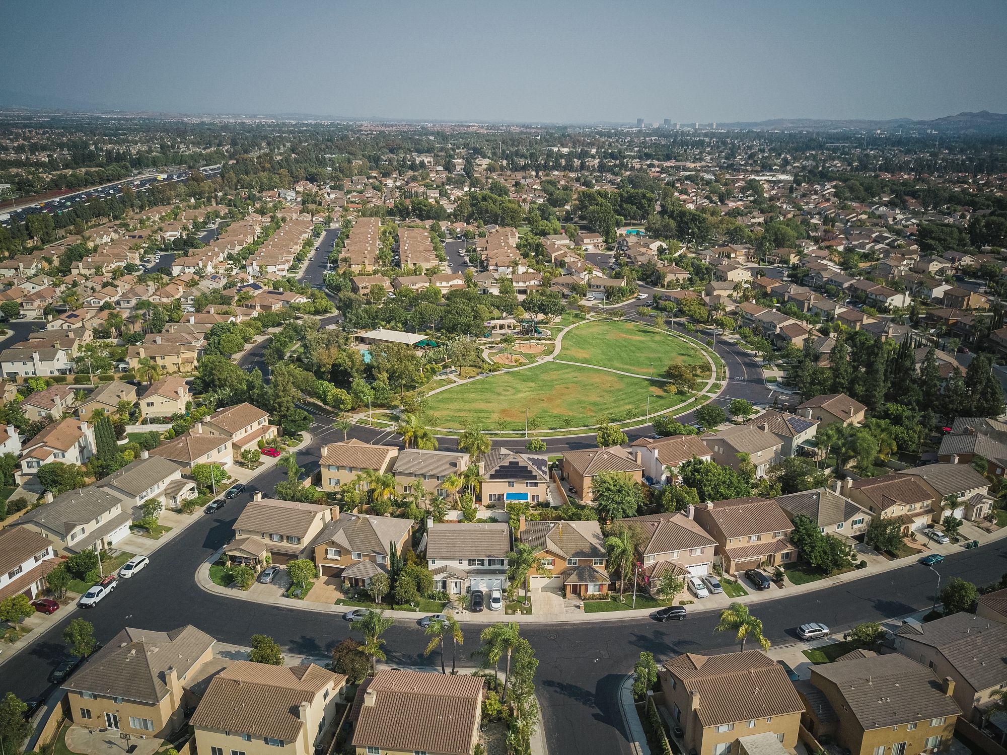 Drone view of a residential neighborhood built around a central park