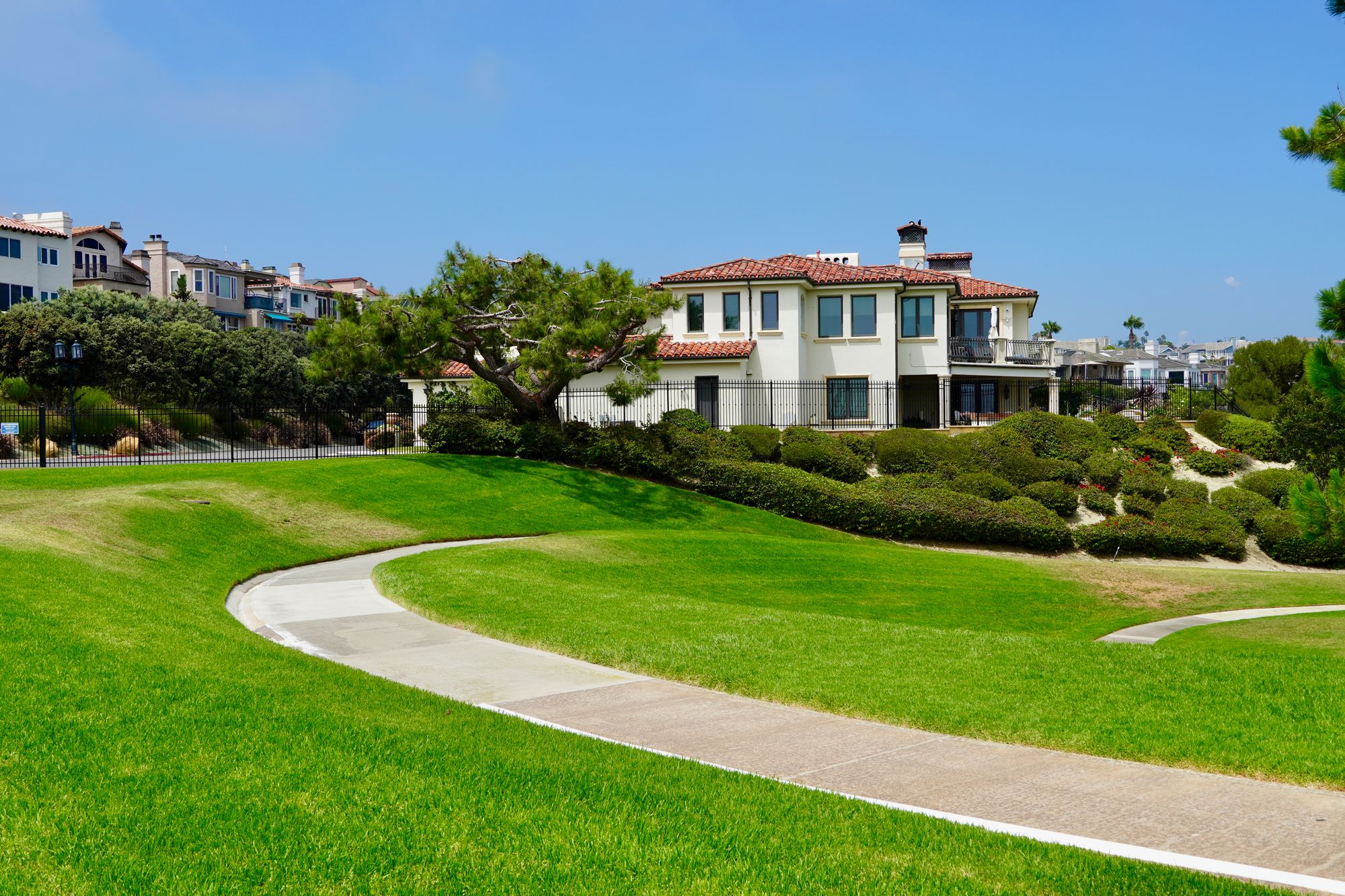 A neighborhood of Mediterranean style homes with green lawns