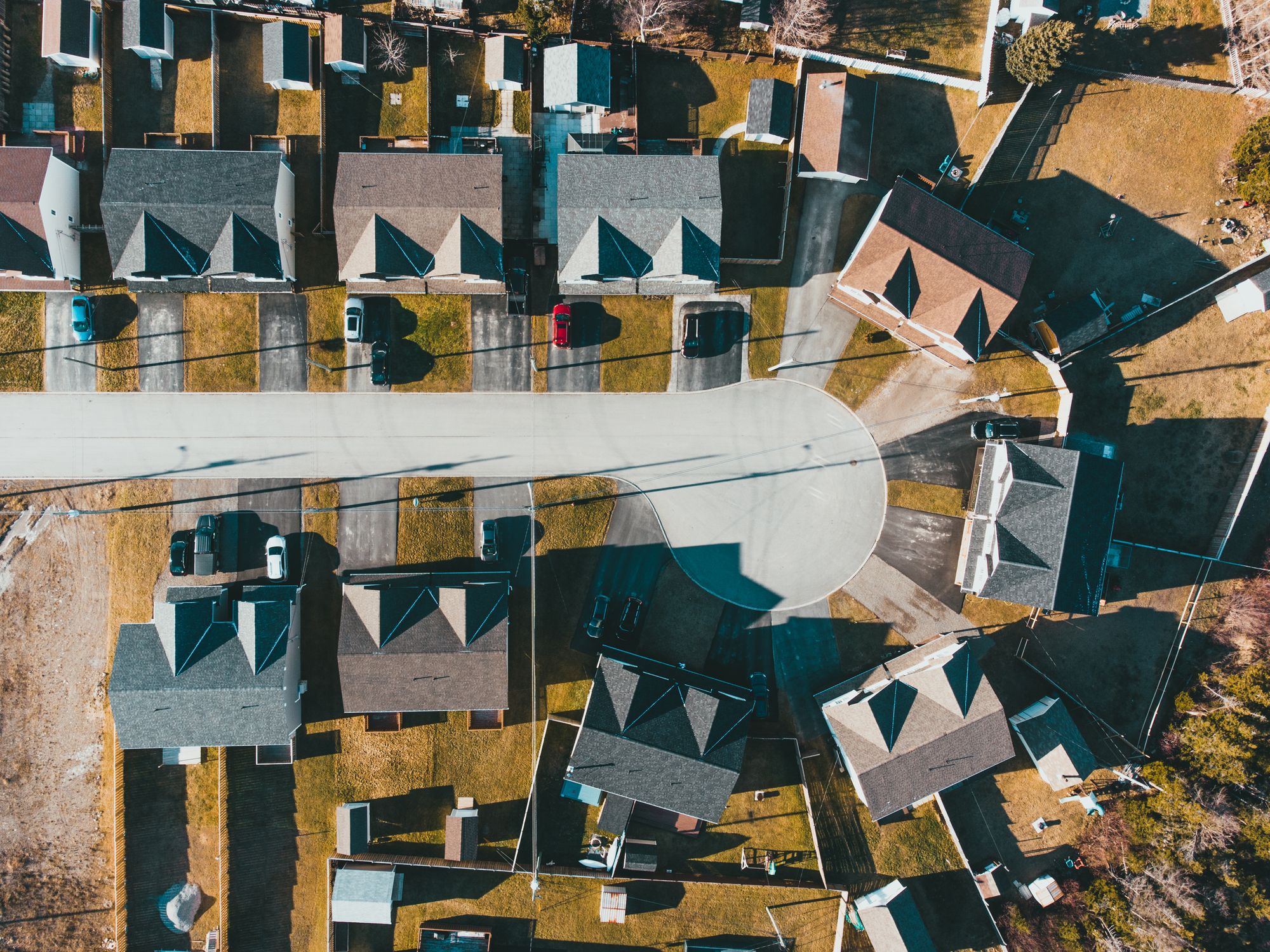 Drone view of a residential district with houses and yards on a sunny day