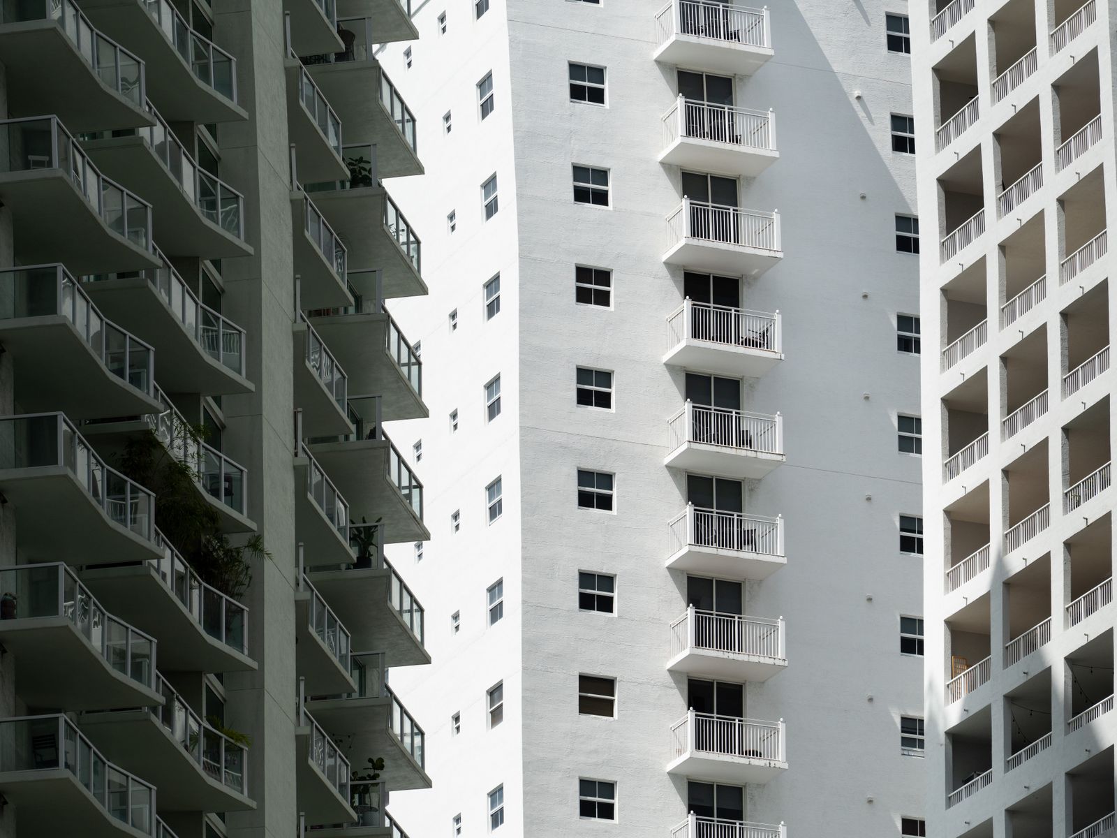 Close up of modern Miami high rise apartment buildings with rows of balconies