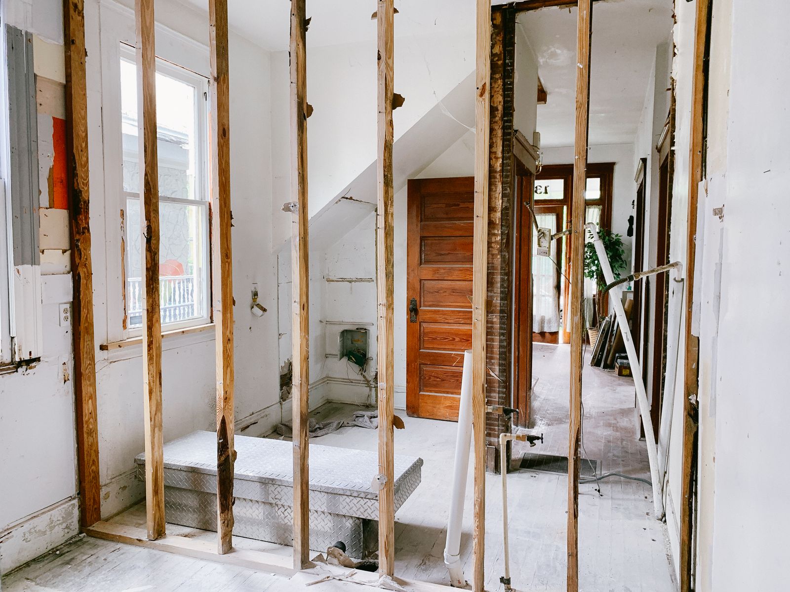 Interior of a house stripped back to exposed wood wall framing during a remodel