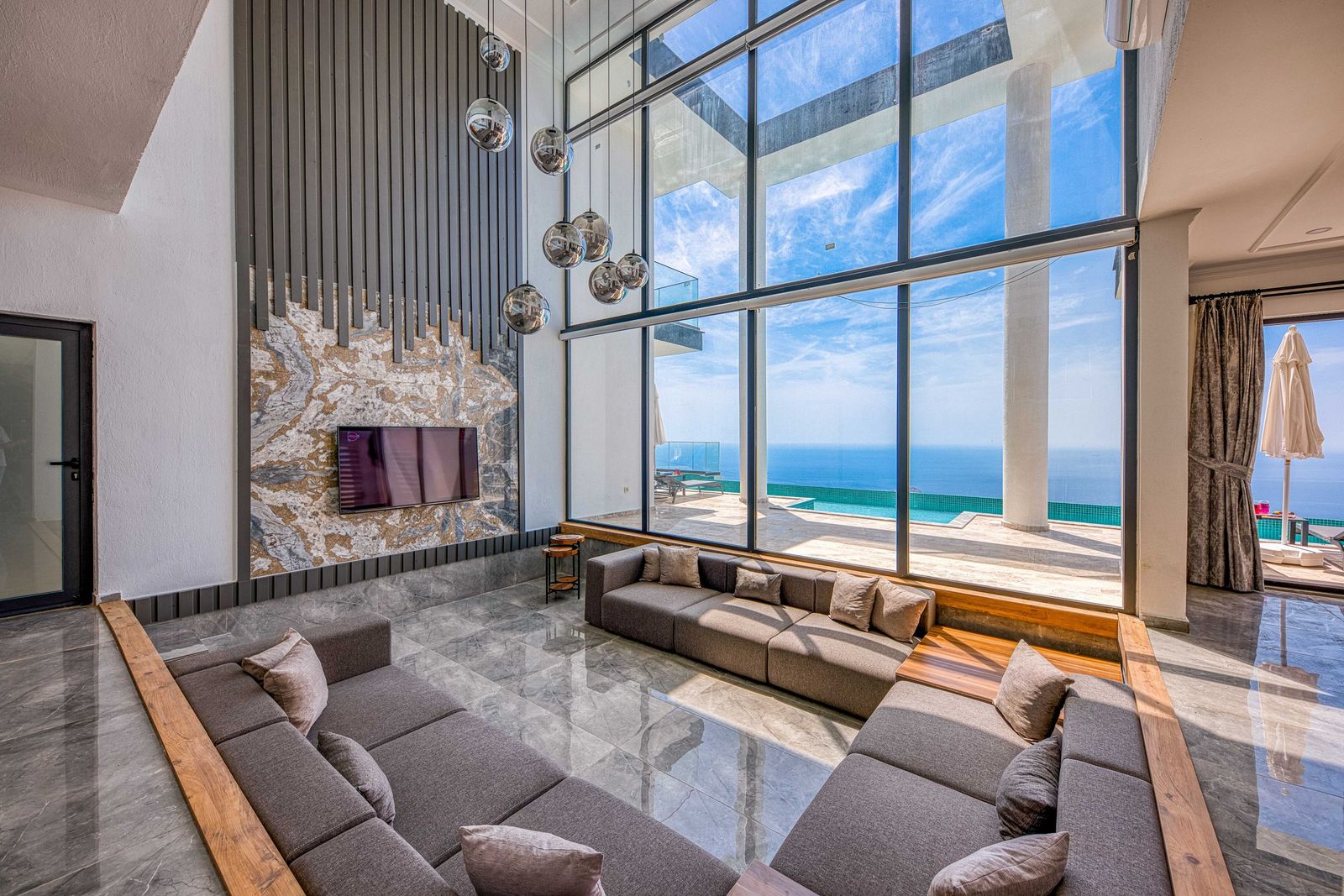 Living room with floor to ceiling windows facing the ocean