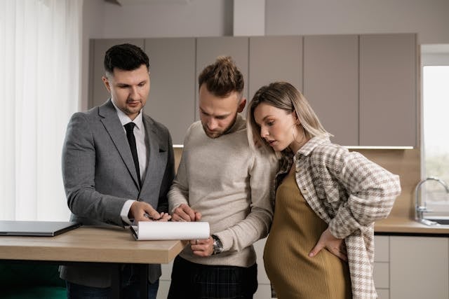 a property manager going over a lease contract with prospective tenants