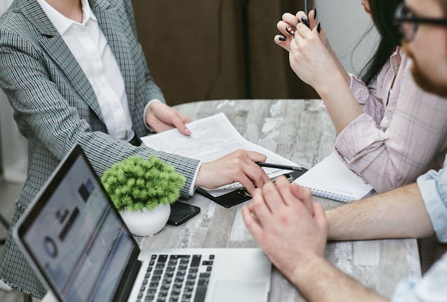 two tenant reviewing a lease with a landlord