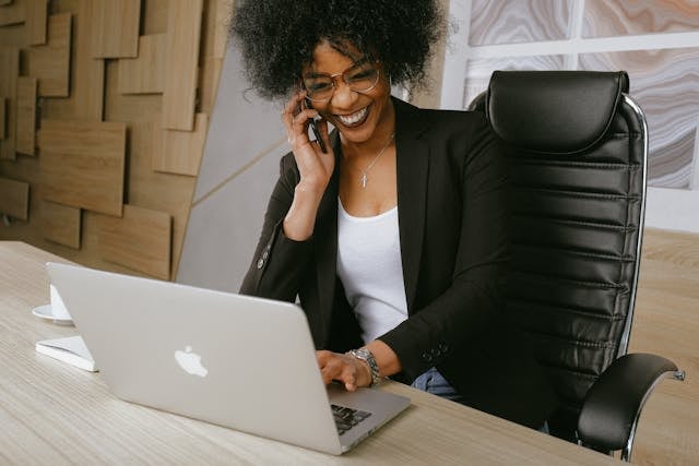 a business person speaking on the phone while at their desk