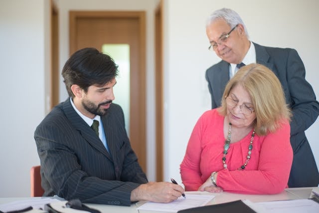 two tenants looking over a lease with a landlord