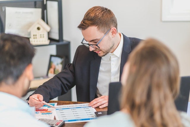 real estate expert going over purchasing documents with buyers