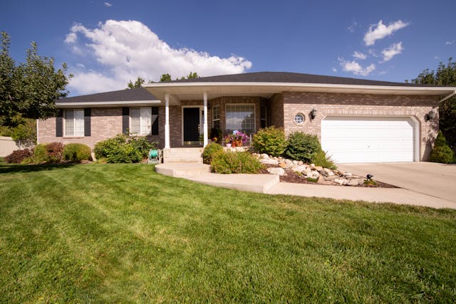 a home with manicured lawn flower beds and clear walkways
