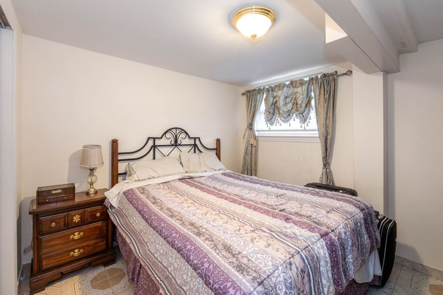 bedroom with a lamp on the bedside table