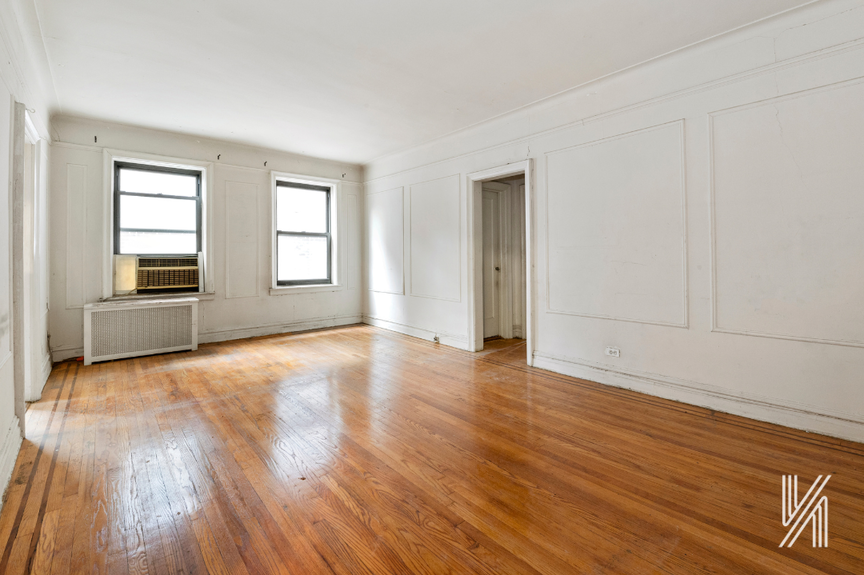 Spacious empty room with two windows
