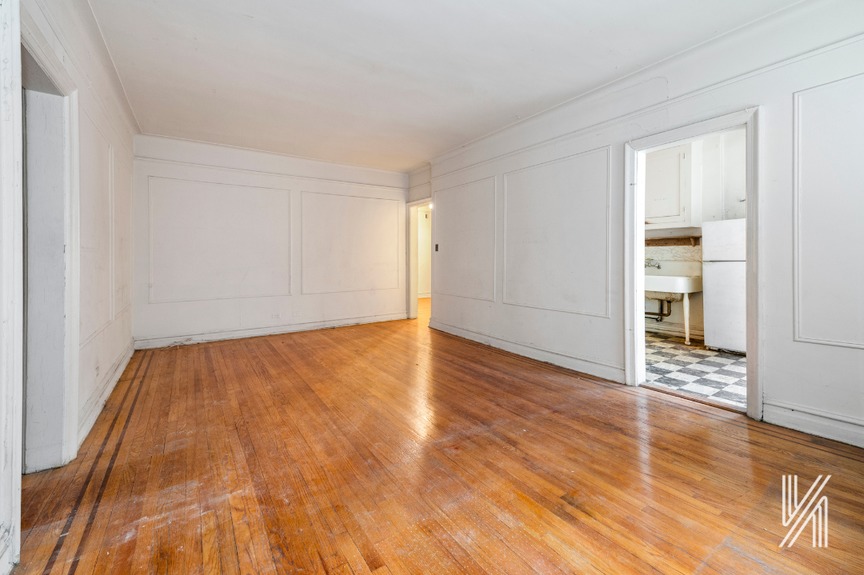 Spacious empty room with wooden floor