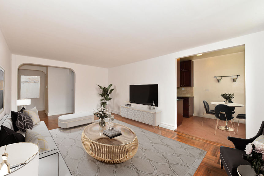 Living room with center table at the top is potted plant and TV