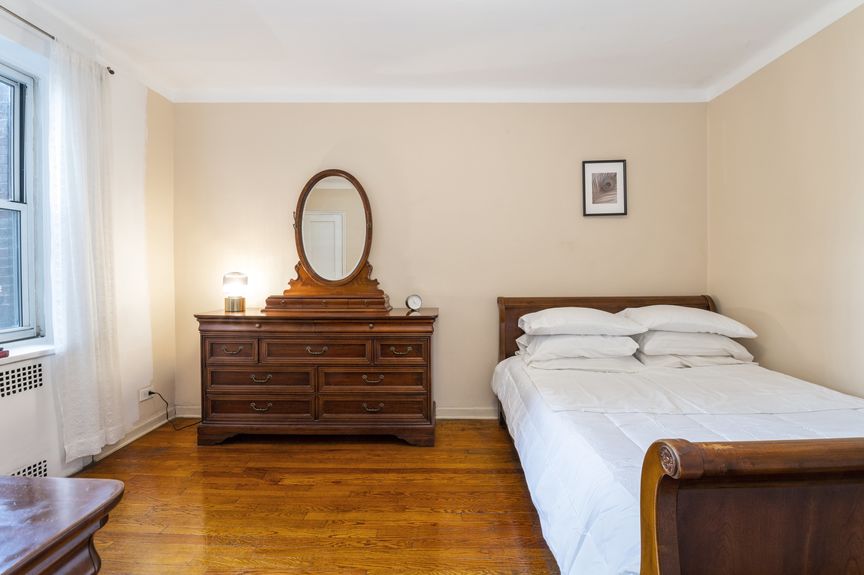 Second bedroom with a sleigh bed and dresser with a mirror.