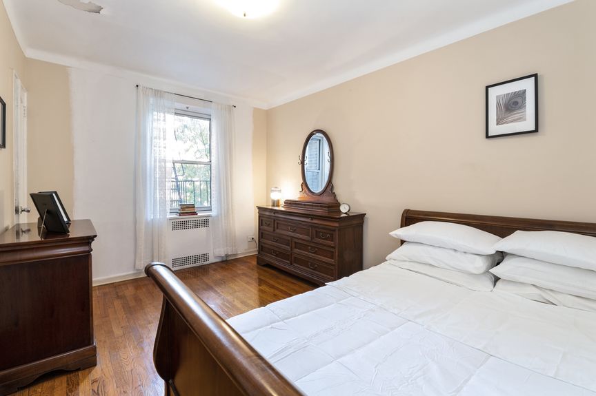 Second bedroom with a sleigh bed and dresser with a mirror.