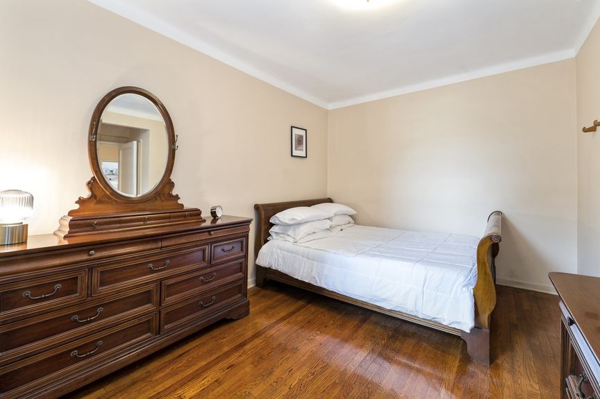 Second bedroom with a sleigh bed and dresser with a mirror.