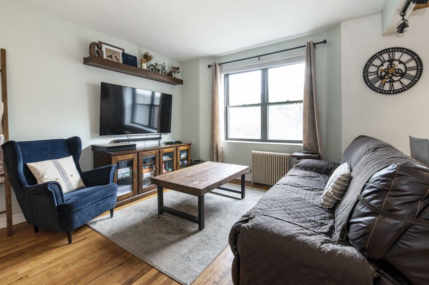 Living room with a couch, table, and tv with a tv stand