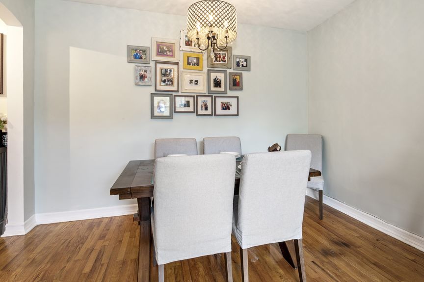 Dining room with a table and four chairs, and a chandelier