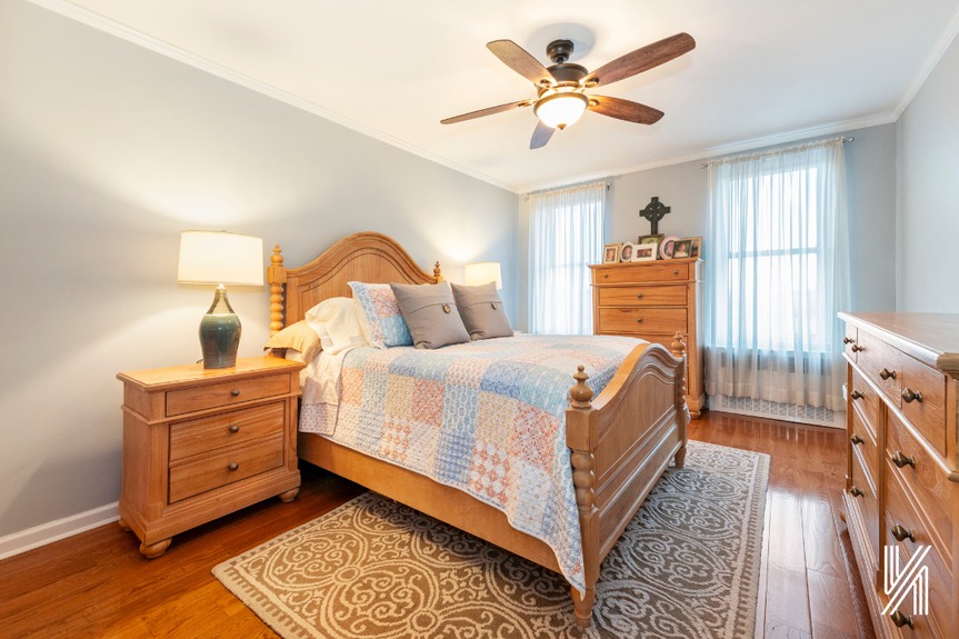 Third with a king-sized bed, two windows, and four wooden cabinetry