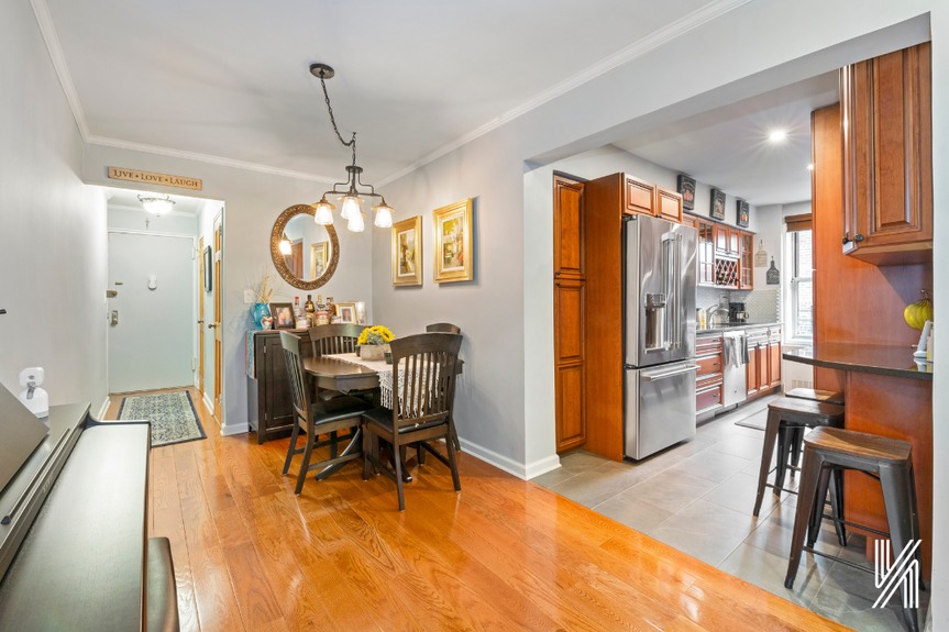 A defined dining area with new radiator covers, crown moldings, and 5” tall baseboards