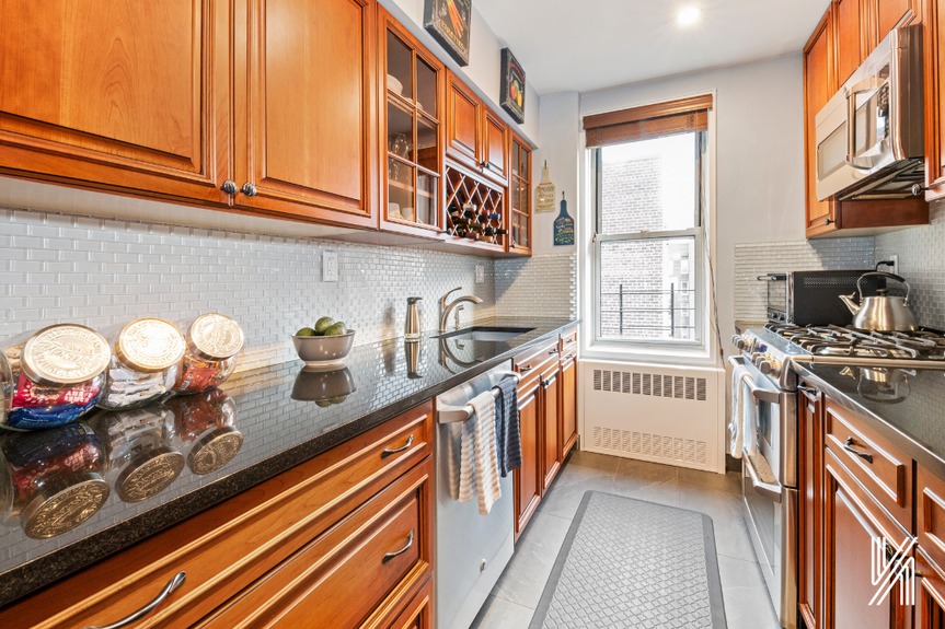 Granite countertops, top-of-the-line stainless steel appliances and an oversized sink