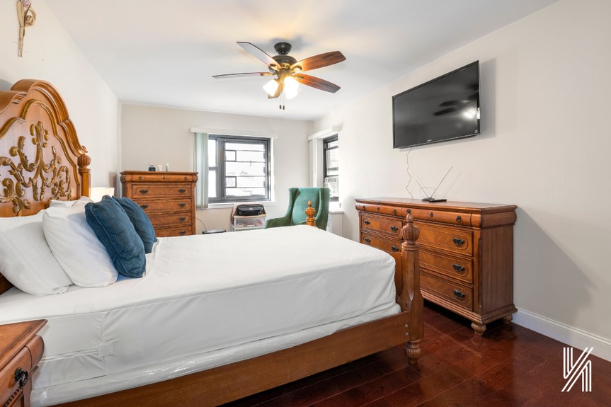 A beautiful bedroom showing the window, elegant built-in fans, and a double-wide closet