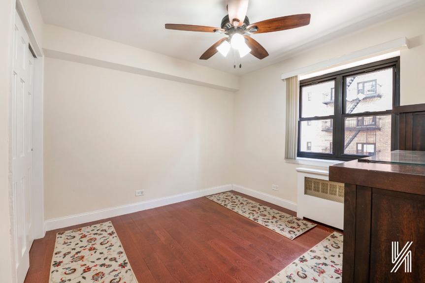 The second bedroom has one window, a double-wide closet, and a built-in fan