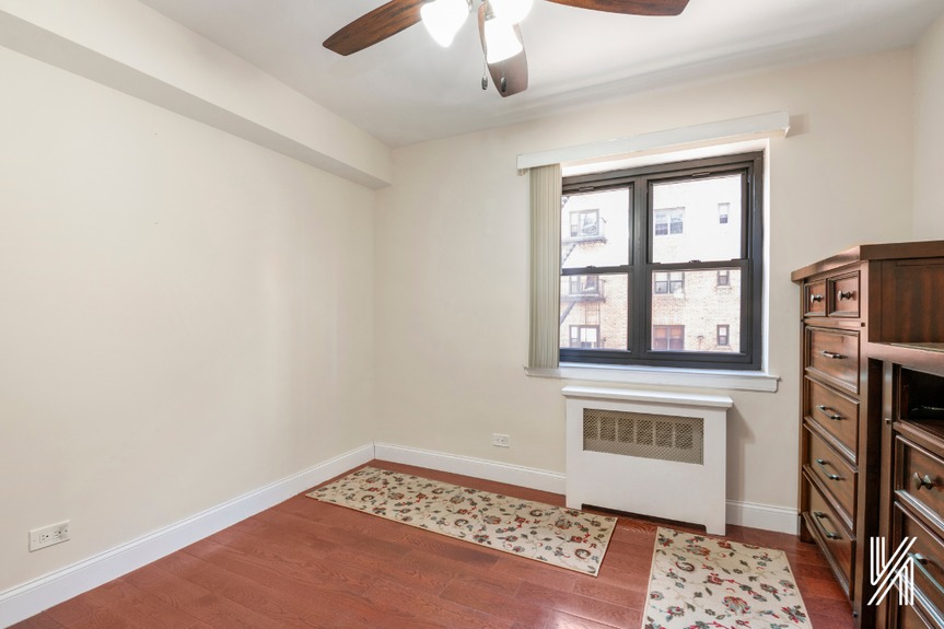 The second bedroom has one window, a double-wide closet, and a built-in fan.