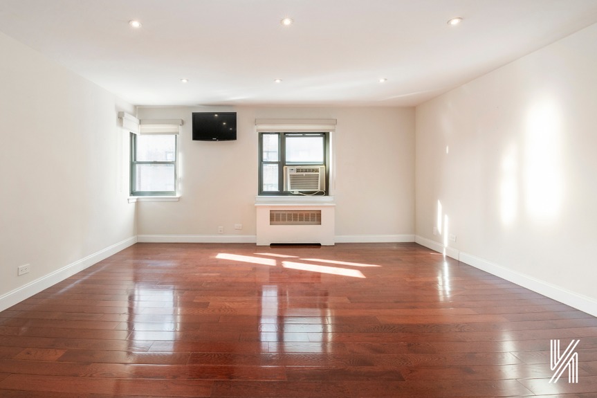 Empty living room showing the two windows