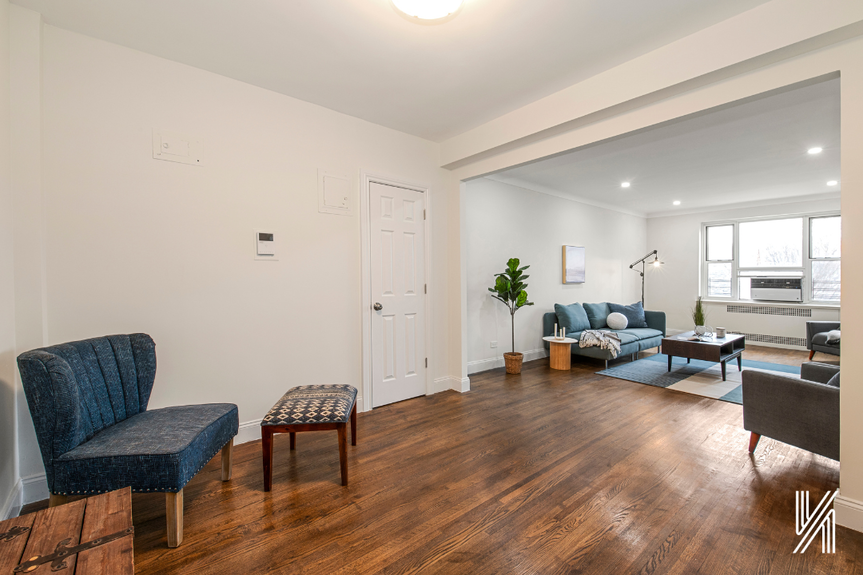 Large open living room with couch and a single sofa