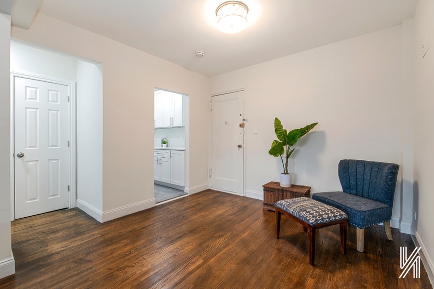 Room with single sofa with 1 door and the view outside kitchen