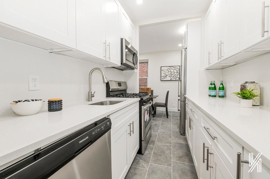 Kitchen with sink, cupboard, and counters