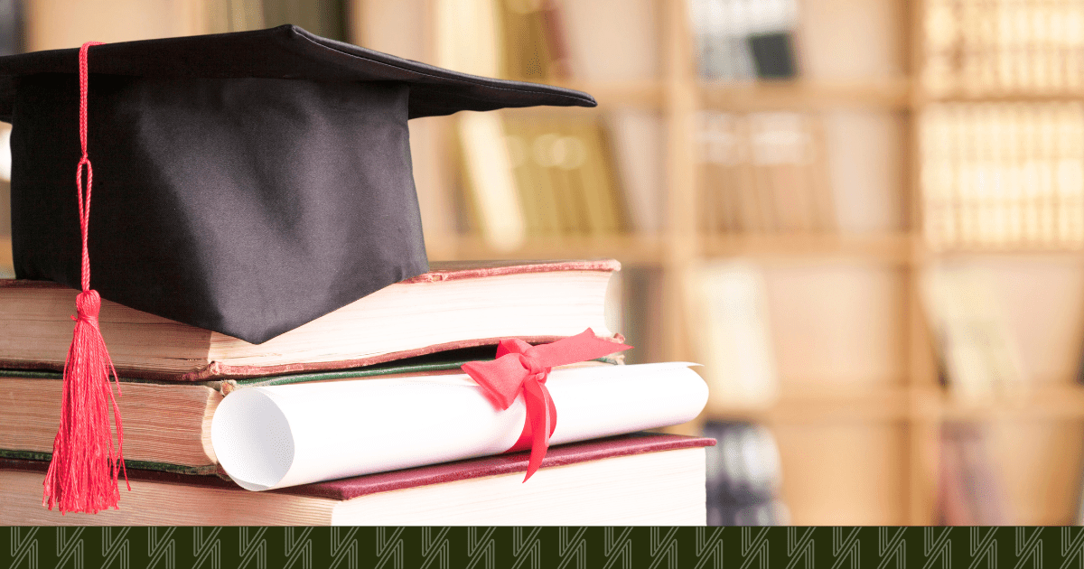 A photo of a graduation cap, books, and a diploma