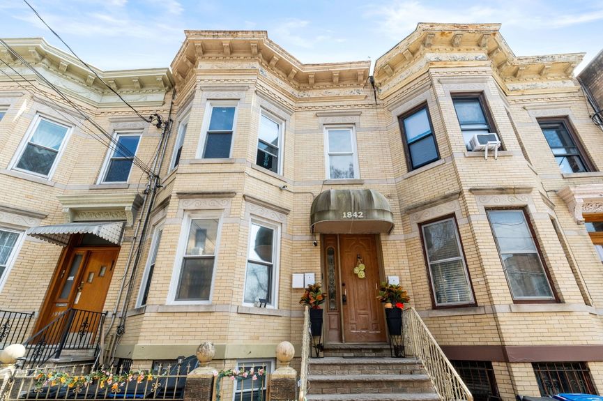 House exterior at 18-42 Norman St, a two-family house in Ridgewood, Queens (11385).