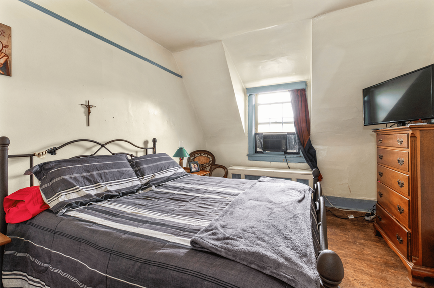 Bedroom at 34-32 84th St, a single-family house in Jackson Heights, Queens (11372).