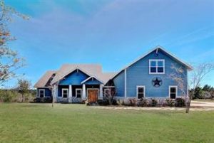 Picture of a blue bricked house in Circle D-KC Estates