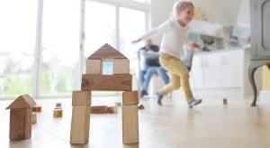 Family at home, child playing with building blocks