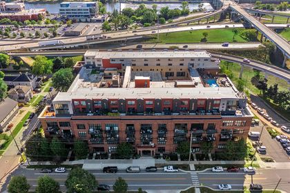 Elevated view of Union Square Condos facing the Grand River and freeway ramps, with brick façade and pool deck visible.