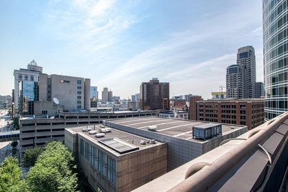 Elevated view looking south toward PNC Bank tower, mid‑rise offices, and construction cranes on the horizon.
