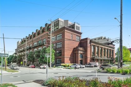 Street‑corner view of Union Square Condos with tall arched windows, brick detailing, and condo balconies.