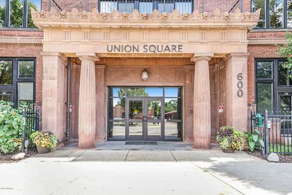 Close‑up of Union Square’s sandstone portico reading “UNION SQUARE,” flanked by twin columns and the address 600.
