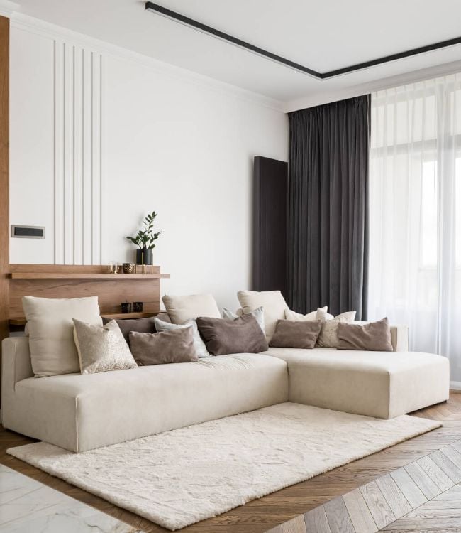 Elegant-and-comfortable-designed-living-room-with-big-corner-sofa-wooden-floor-and-big-windows-1