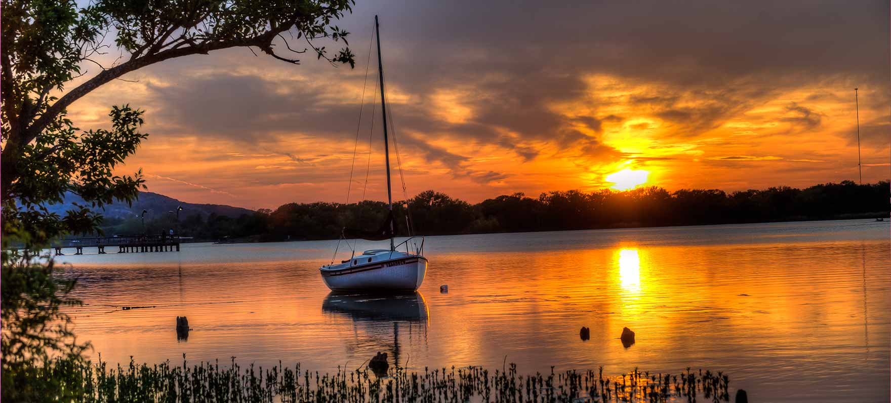 "Lowered water level at Inks Lake during the 2025 scheduled drawdown, exposing shoreline for dock repairs and maintenance.