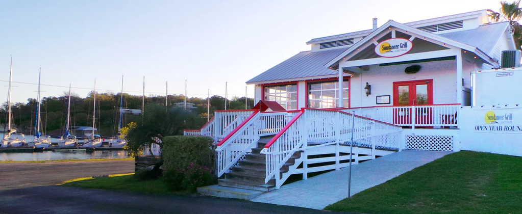 Sundancer Grill waterfront restaurant on Lake Travis with boat-up access, marina views, and casual dockside dining